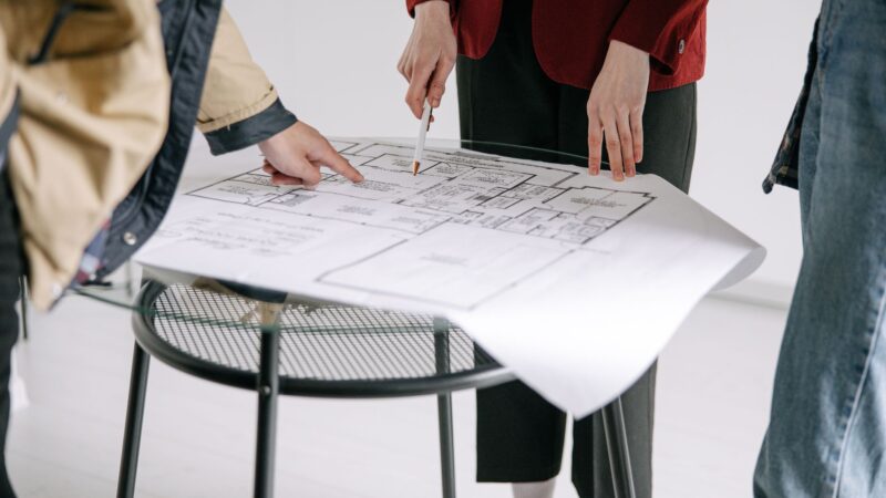Architecte travaillant sur des plans dans un bureau moderne pour optimiser le référencement local de son agence